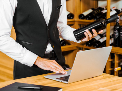 Somalier checking bottle of wine to be shipped.